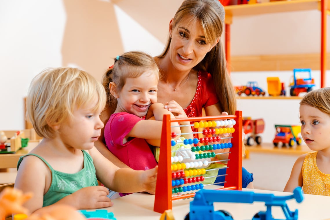 Preschool Teacher Playing with the Children